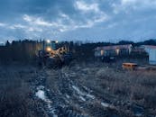 Blue Image of a Tractor on Field in Dusk and Overcast