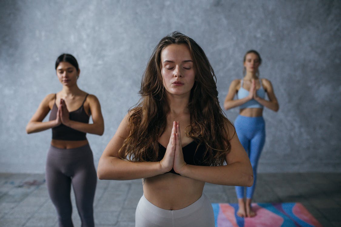 Free Photograph of Women Meditating with Their Eyes Closed Stock Photo