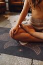Photo of a Woman Meditating on a Black Yoga Mat