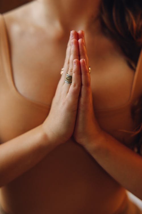 Woman Wearing Ring in Praying Hands Position 