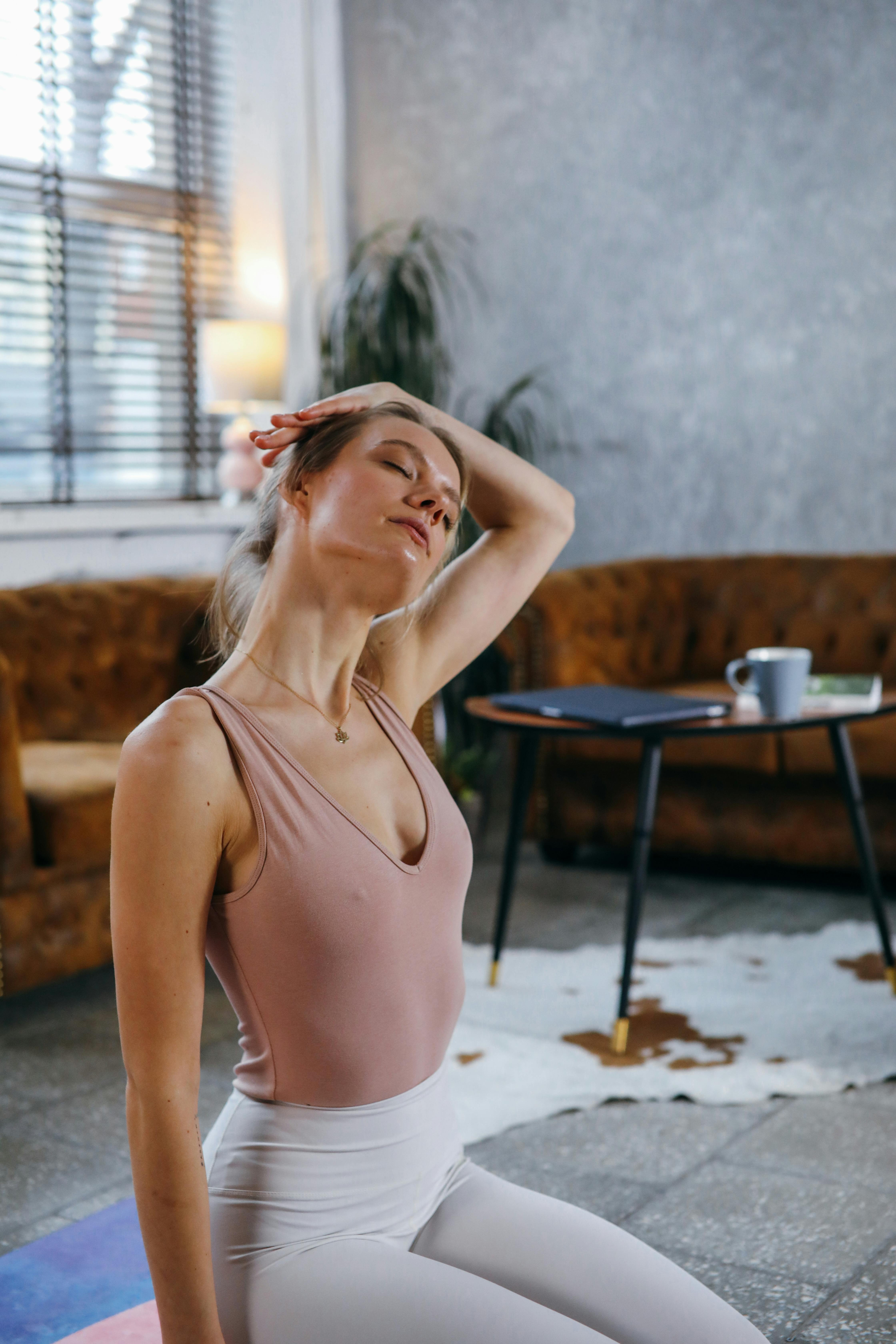 woman in beige tank top doing yoga practice