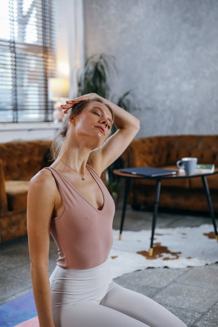 Woman In Beige Tank Top Doing Yoga Practice