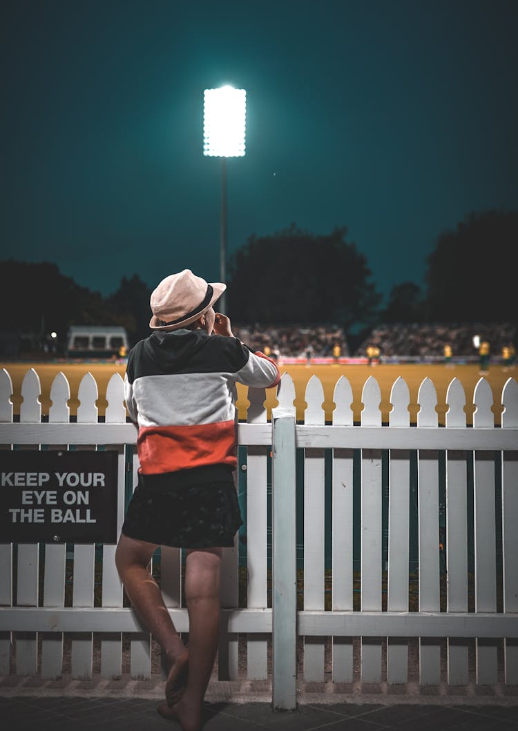 Person Leaning On Wooden Fence