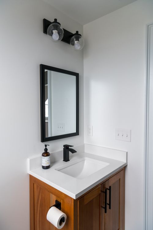 Free Elegant minimalist bathroom vanity design featuring sleek sink and mirror in neutral tones. Stock Photo