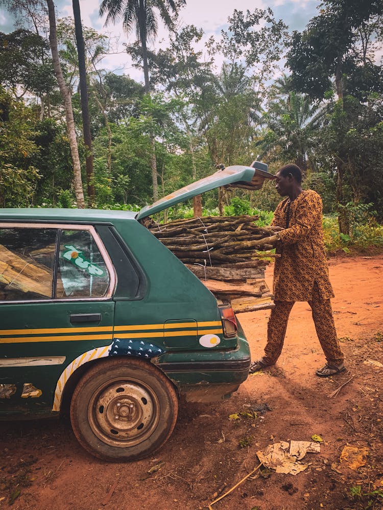 Man Loading Wood Into Car