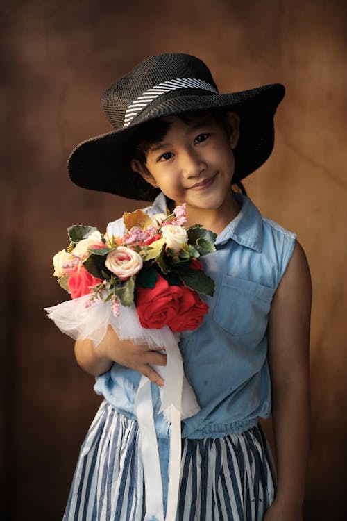 Cute Asian kid with flowers