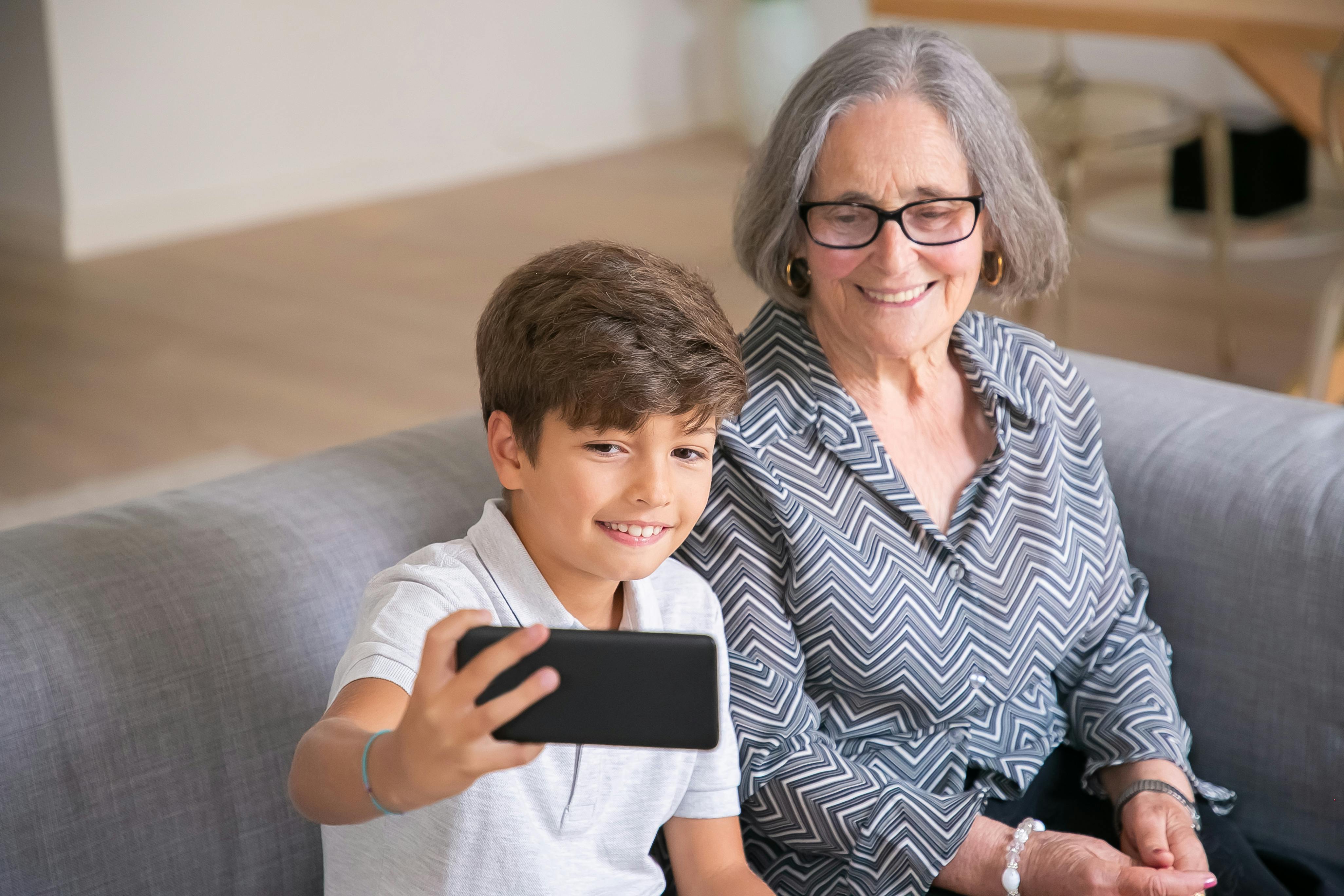 grandchild taking a photo with his grandma