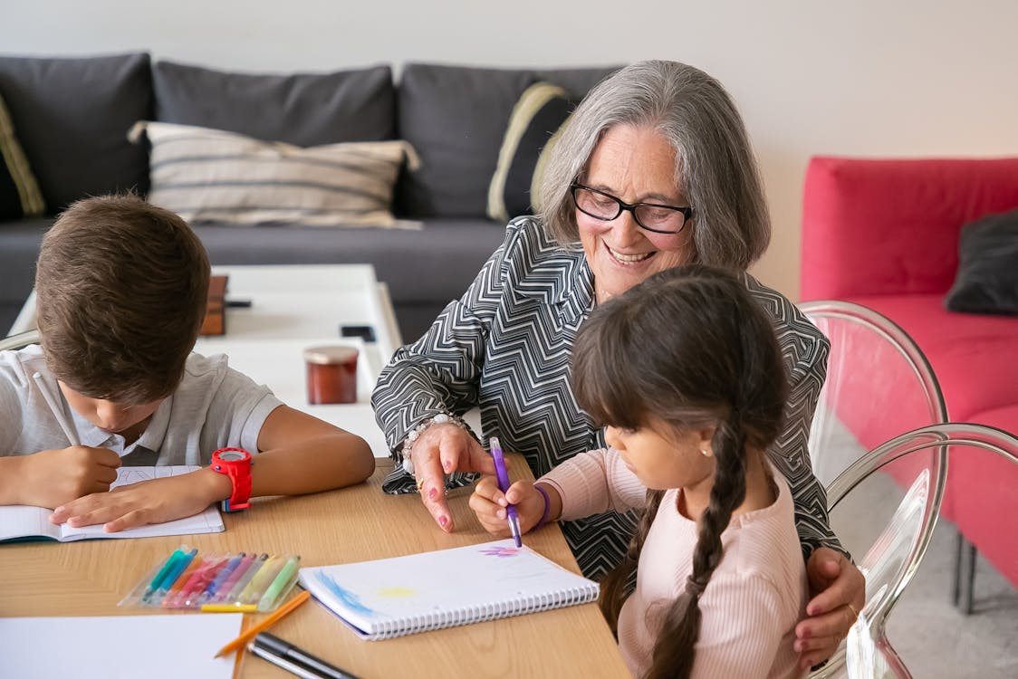 Free Grandmother helping her Grandchildren with their Homework Stock Photo