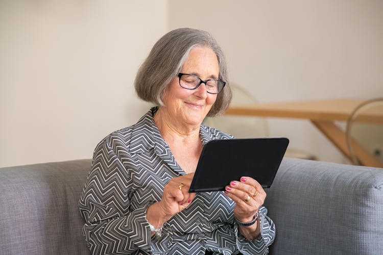 Smiling Senior Using Tablet