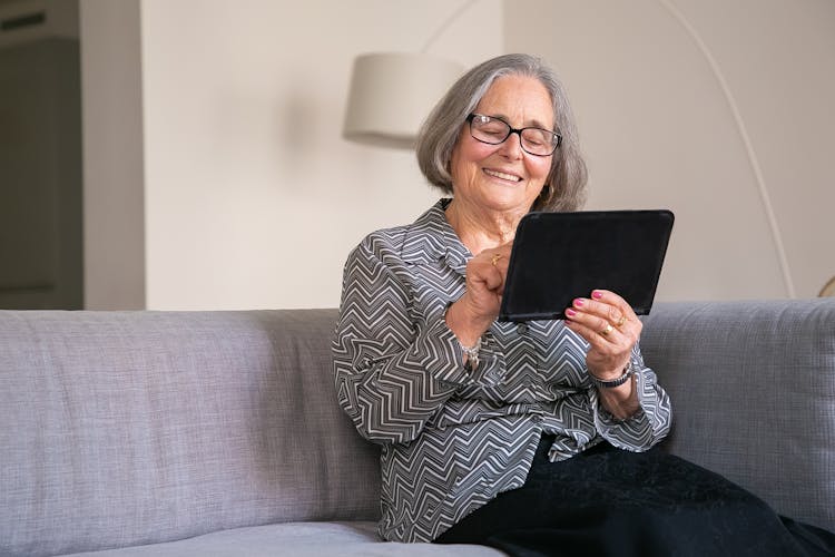 Photo Of An Elderly Woman Using Her Tablet