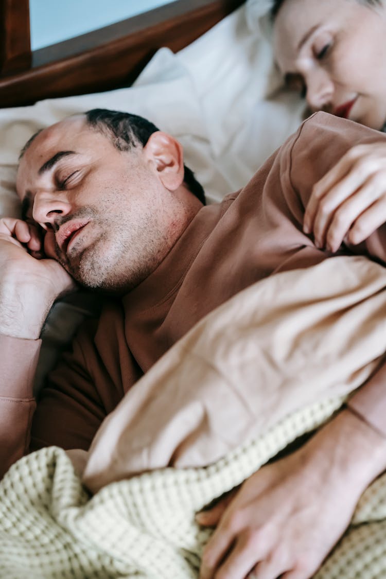 Calm Couple Sleeping In Soft Bed