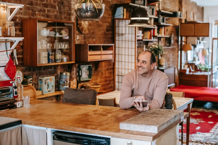 Candid Man With Smartphone At Table In House