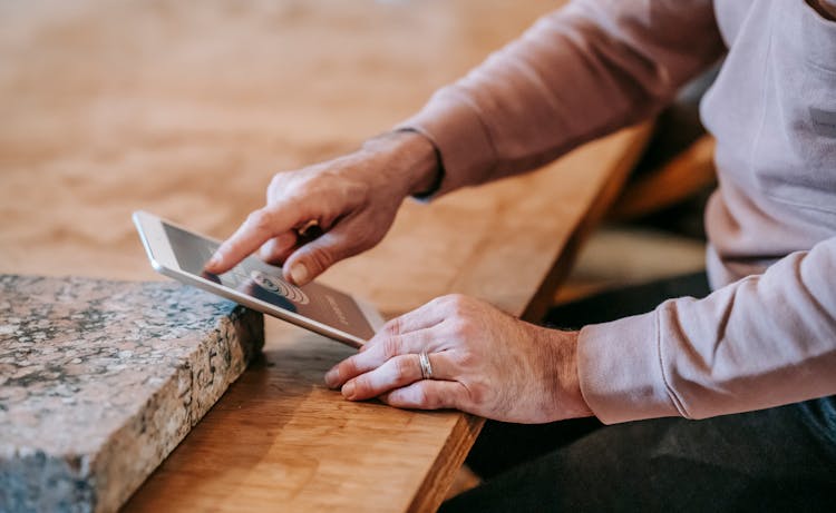 Anonymous Man Using Tablet During Remote Work At Home