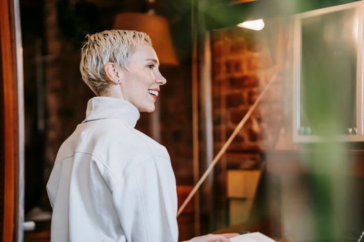 Cheerful woman with stylish haircut smiling