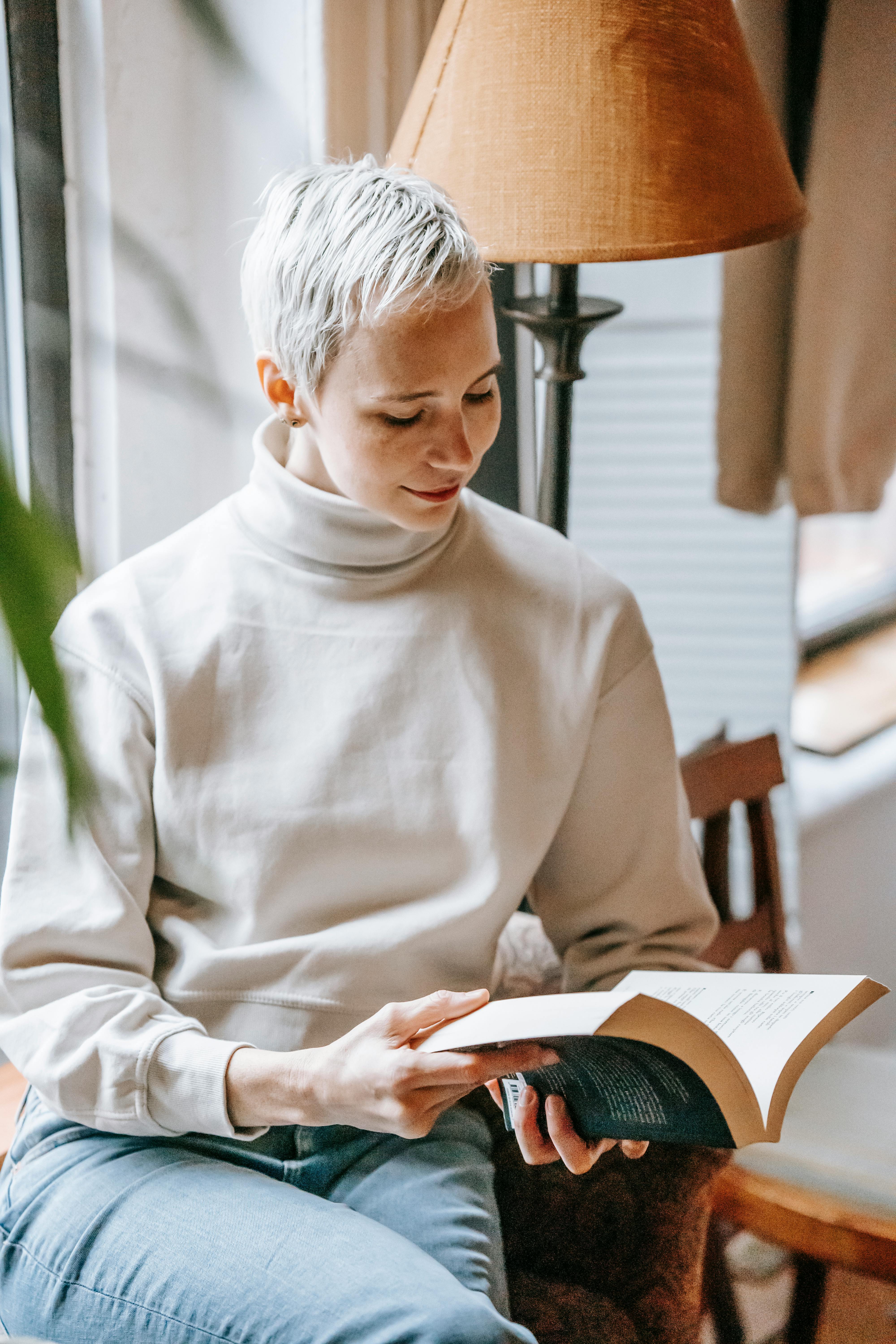 content stylish woman reading fascinating book