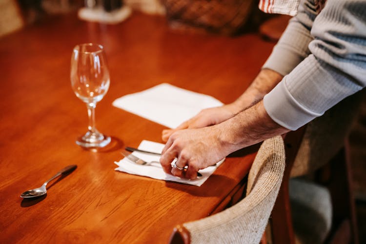 Faceless Man Serving Table At Home