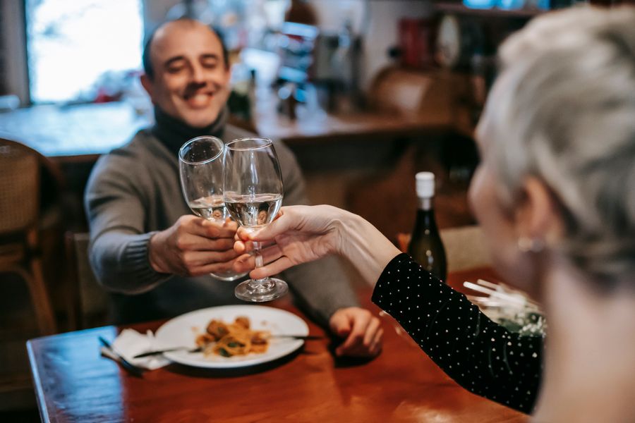 A happy couple toasting at dinner