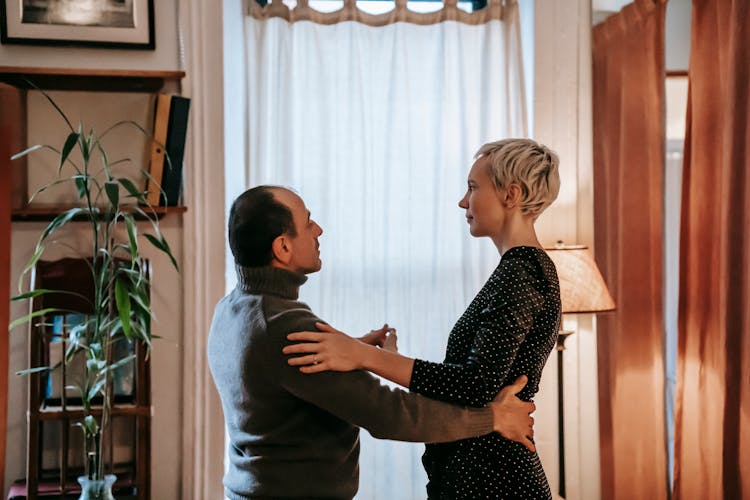 Elegant Couple Dancing In Modern Apartment