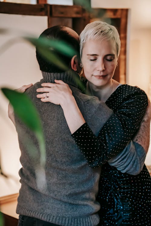 Tender couple gently embracing in room