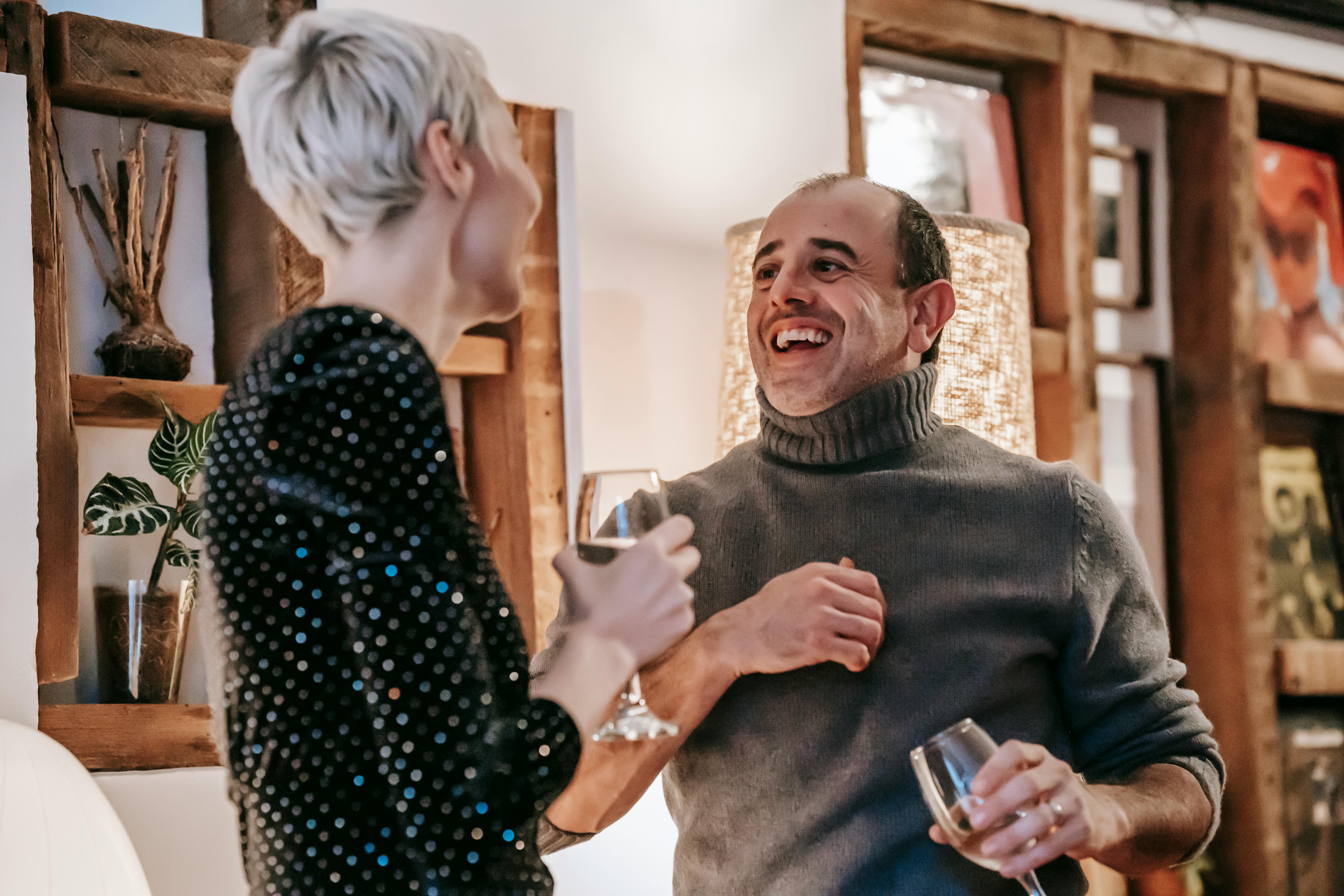 positive couple drinking wine and laughing