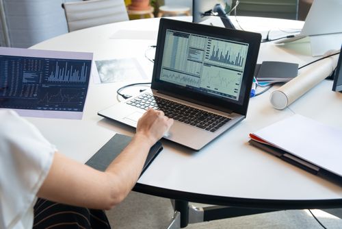 Paper and laptop with graphs