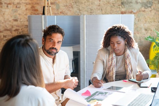 A diverse group of colleagues having a constructive discussion in a modern office setting.