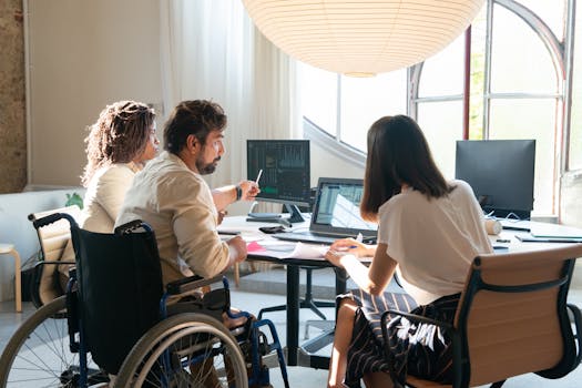 Diverse group of coworkers in a bright office working together around a table.