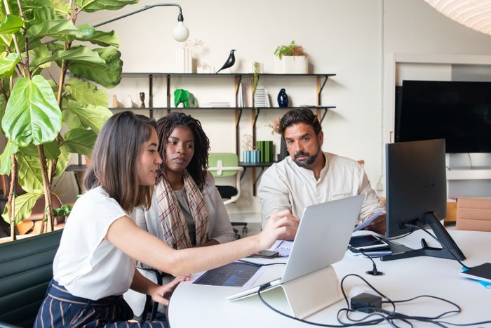 Three colleagues reviewing work on a laptop — photo by Kampus Production on Pexels