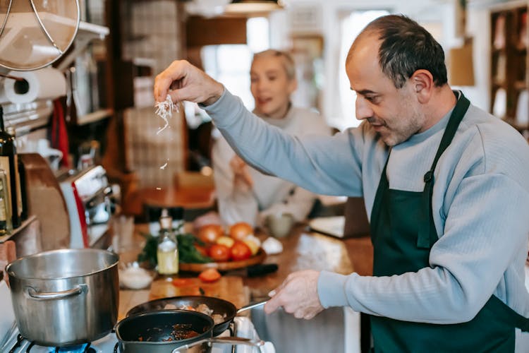 Man Preparing Food On Stove For Lunch