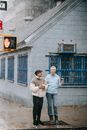 Smiling couple standing on stop traffic light