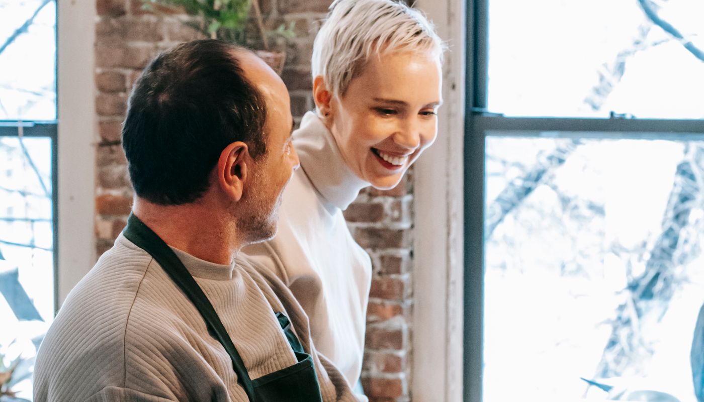 better sex tips — Happy couple cooking dinner together in kitchen · Free. Photo: Pexels