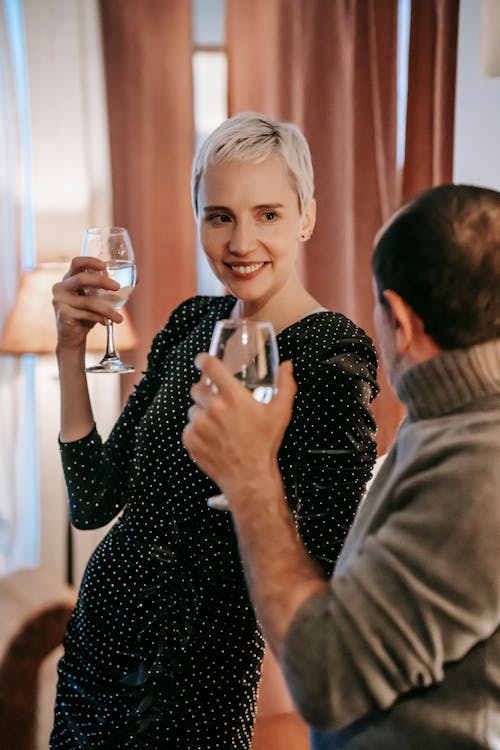 Free Positive couple with wineglasses in room Stock Photo