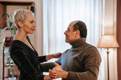 Delicate couple having romantic dance in apartment