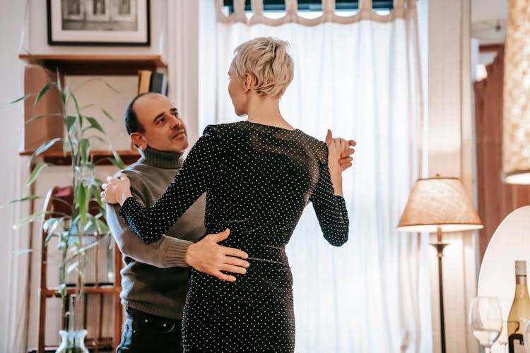 Couple Dancing Together In Living Room