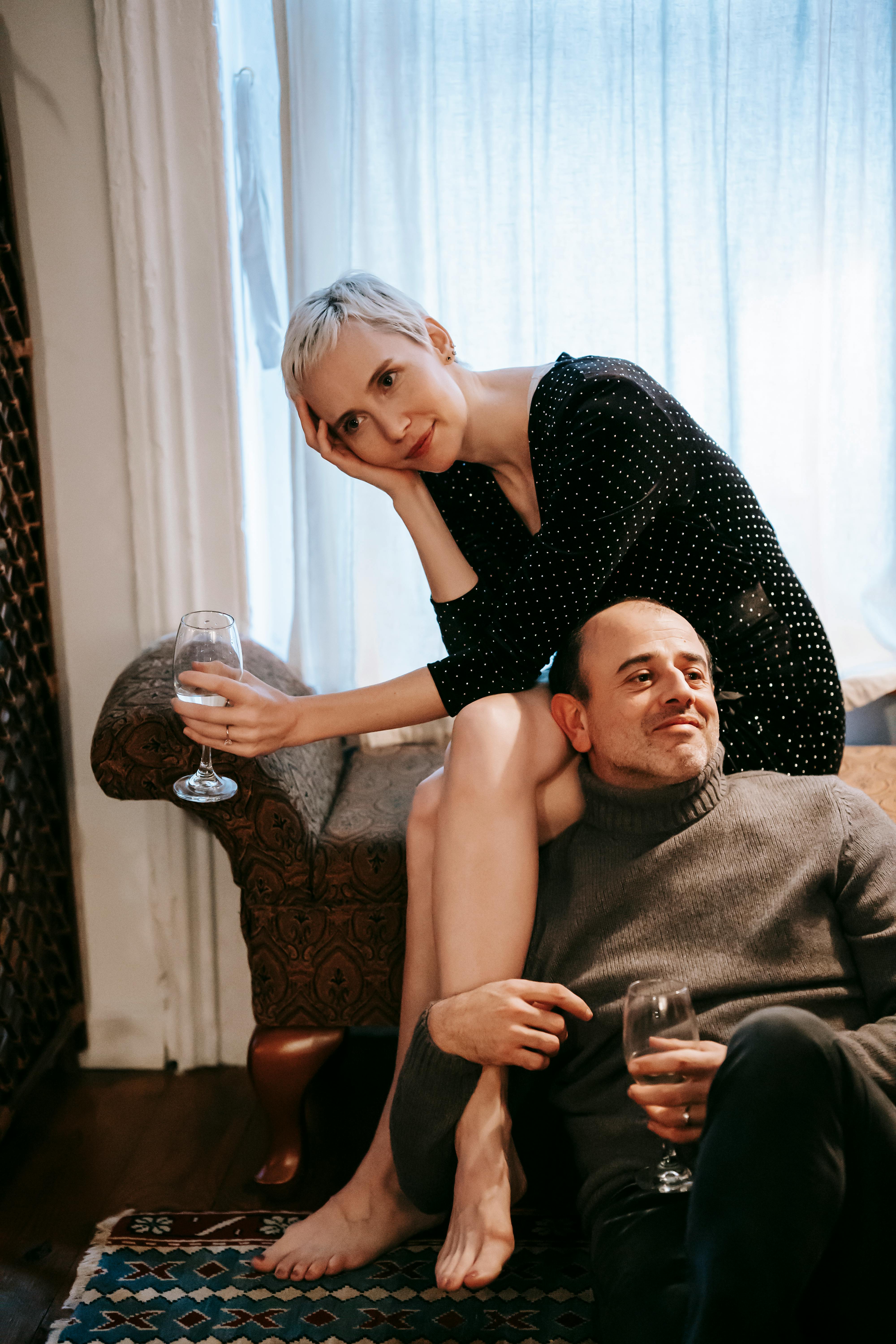 relaxed couple drinking wine from glassware