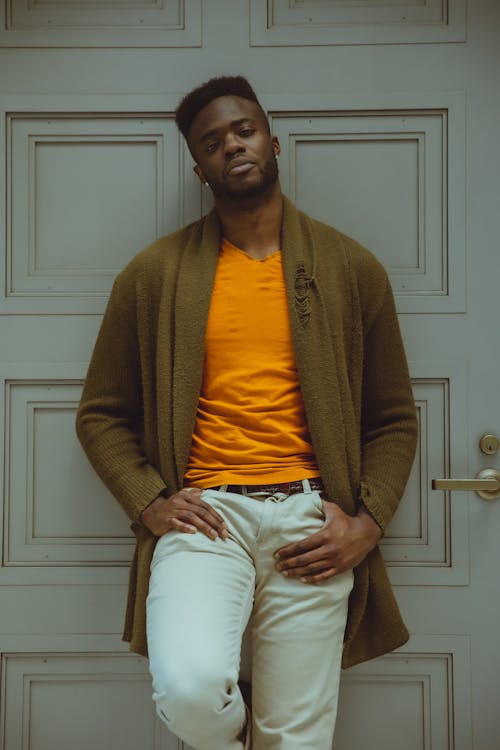 Stylish black man standing near door