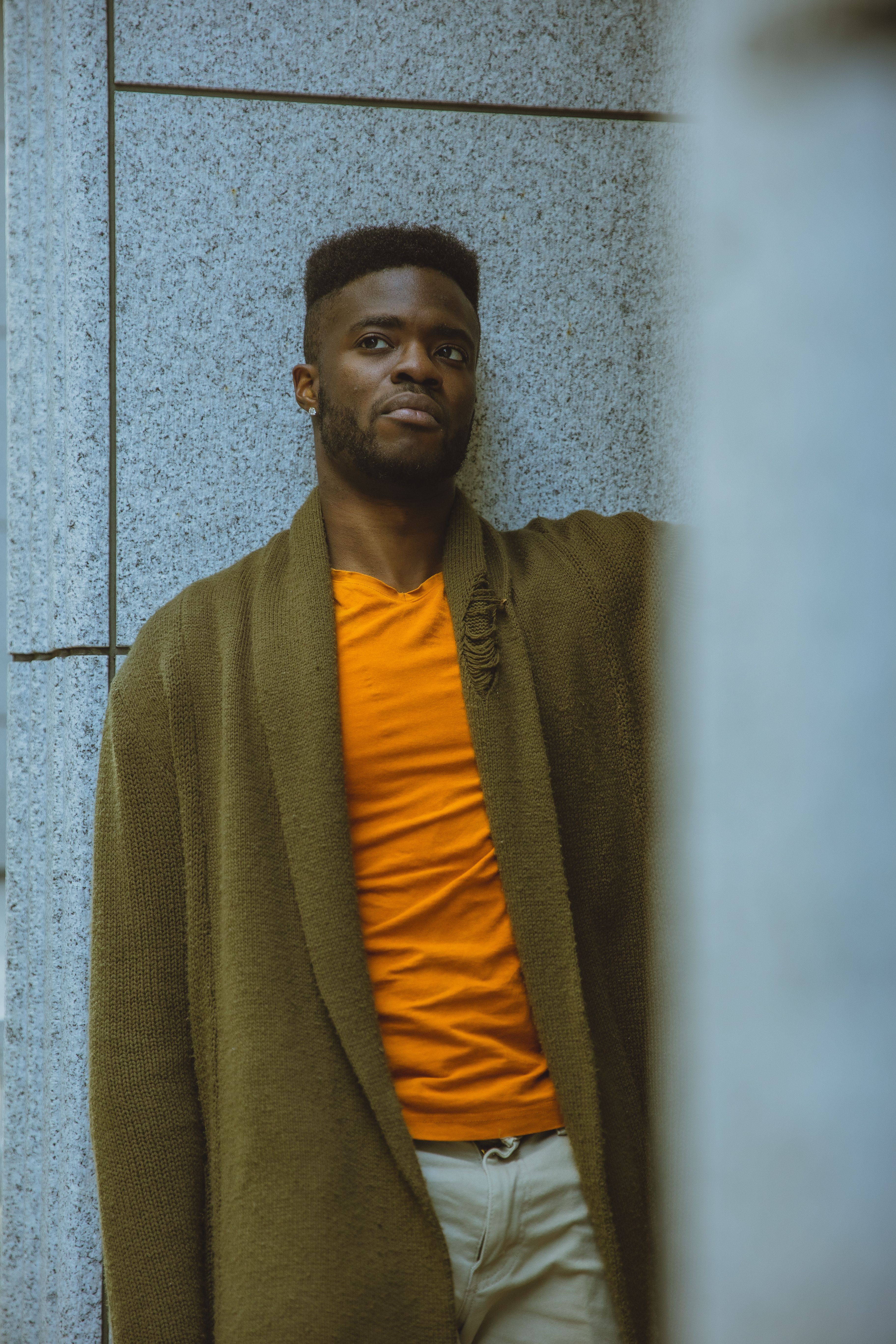 Serious black man standing near transparent building · Free Stock Photo