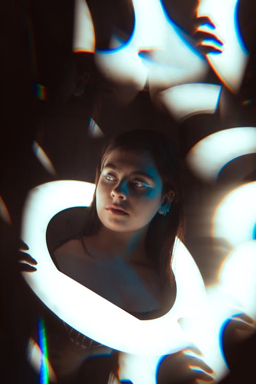 A Pretty Woman Holding a Ring Light