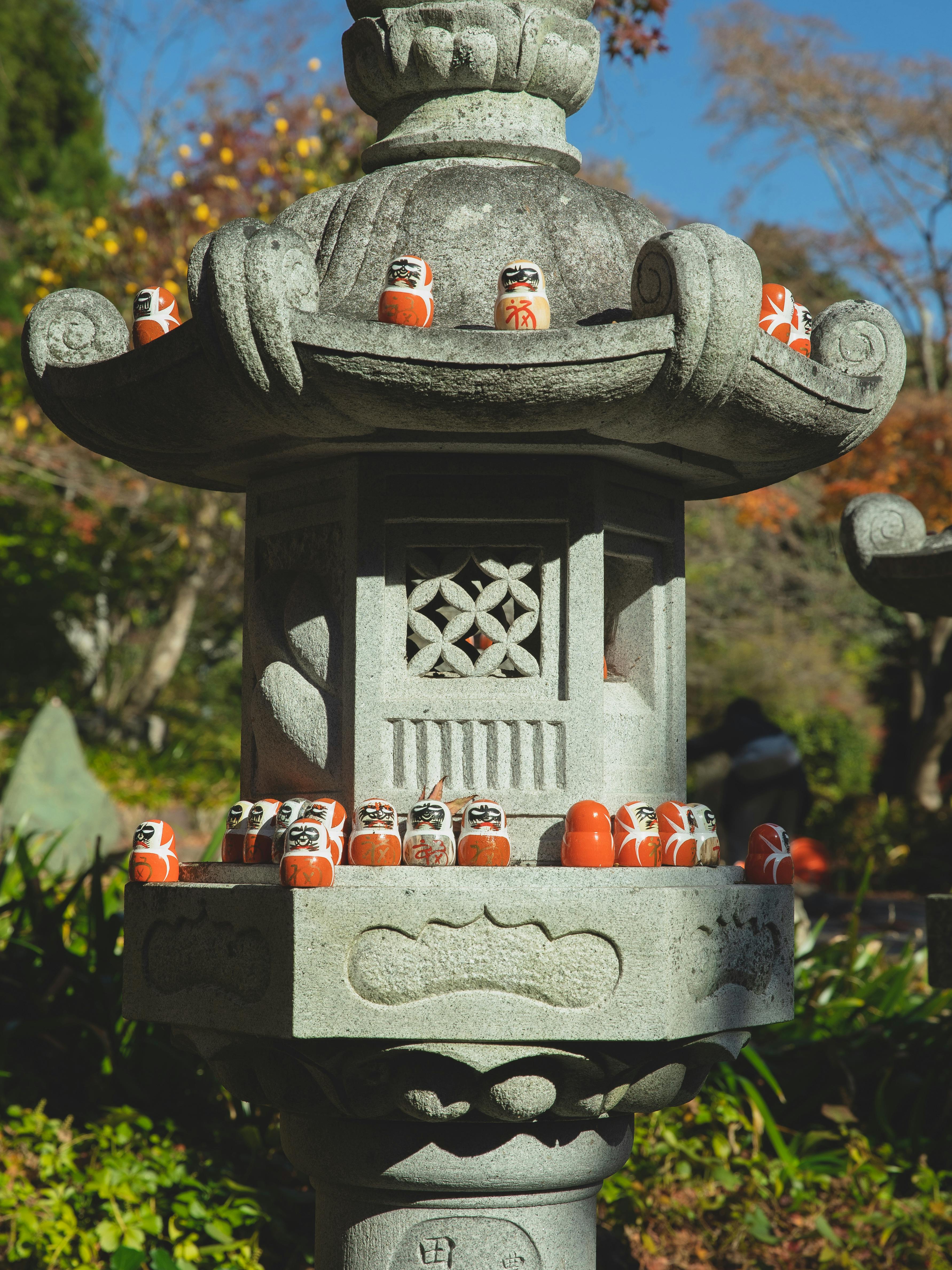 traditional daruma dolls om stone monument