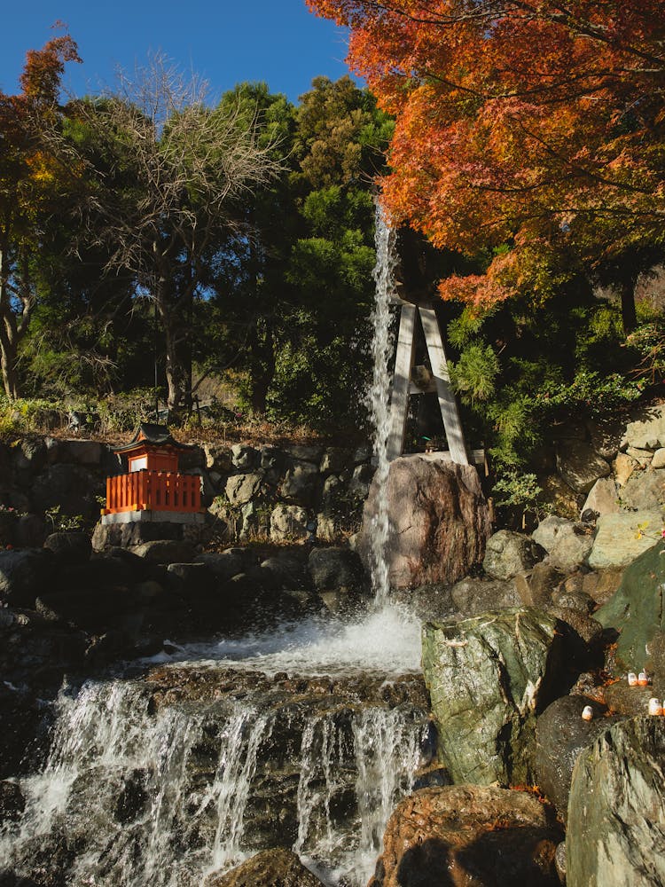 Powerful Waterfall On Rocky Formation On Sunny Day