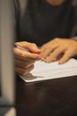 Man writing with pen on paper