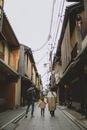 Parents walking with daughter among old houses
