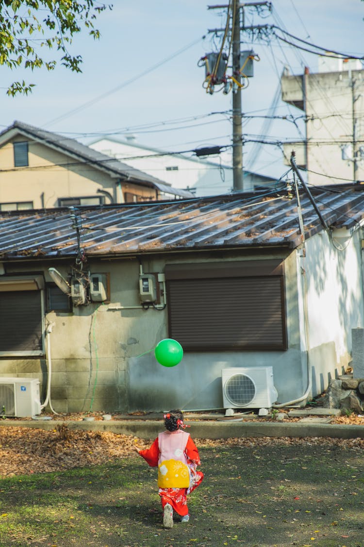 Cute Japanese Girl In Kimono With Balloon On Children Day