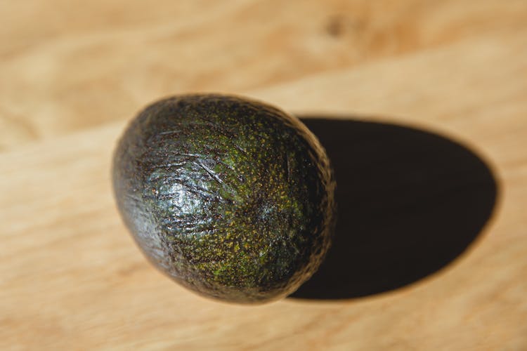 Fresh Ripe Whole Avocado On Wooden Table