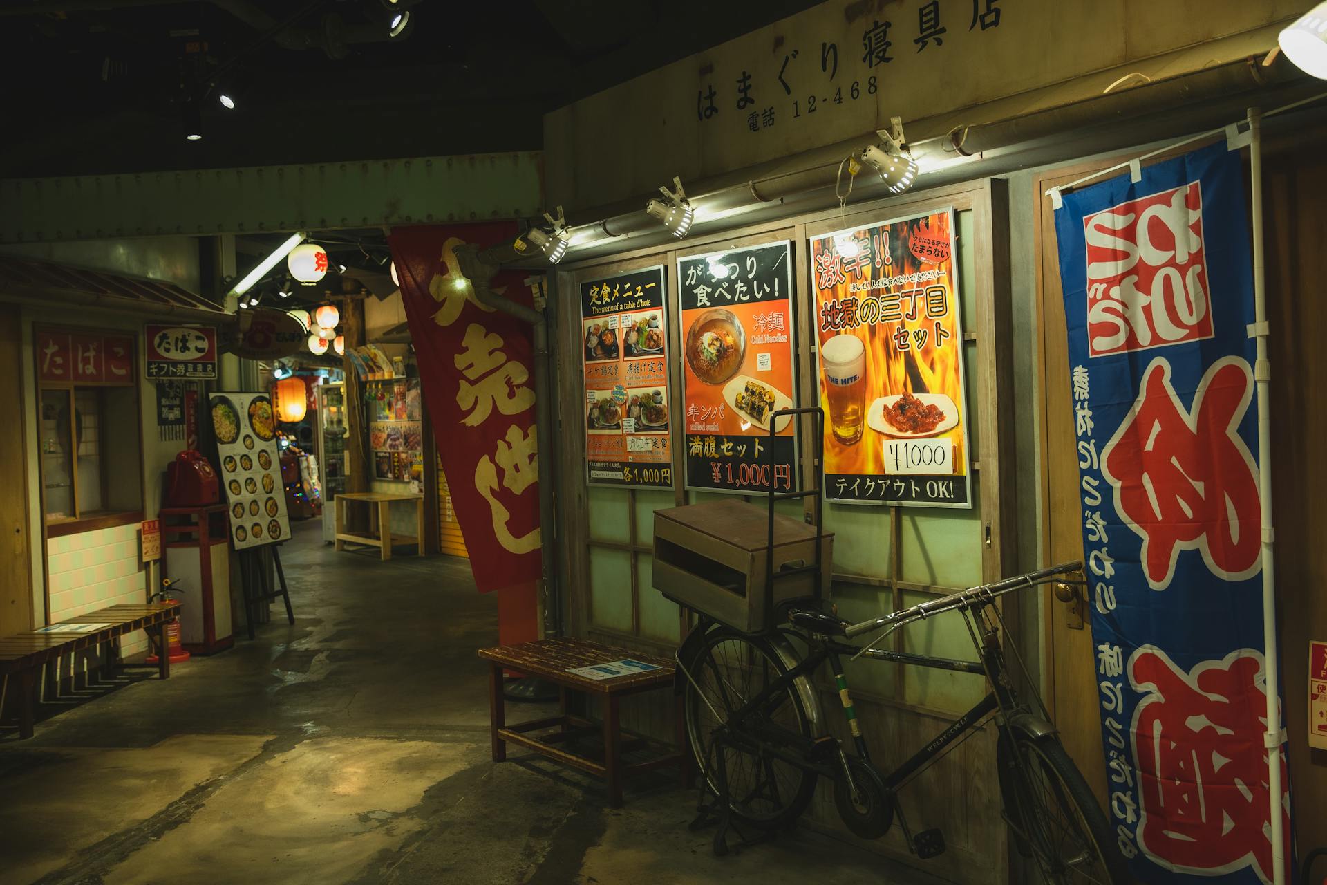 Exterior of street with parked bicycle near cafe with advertisement of food and drinks with prices