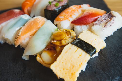 Free High angle of delicious assorted nigiri sushi covered with different pieces of fish on table Stock Photo