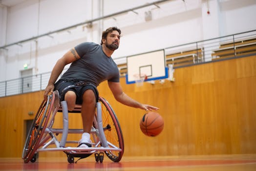 A focused man playing wheelchair basketball indoors, showcasing determination and skill.
