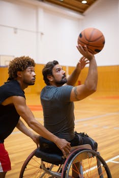 Two men engage in a dynamic basketball training session, showcasing inclusivity and teamwork.