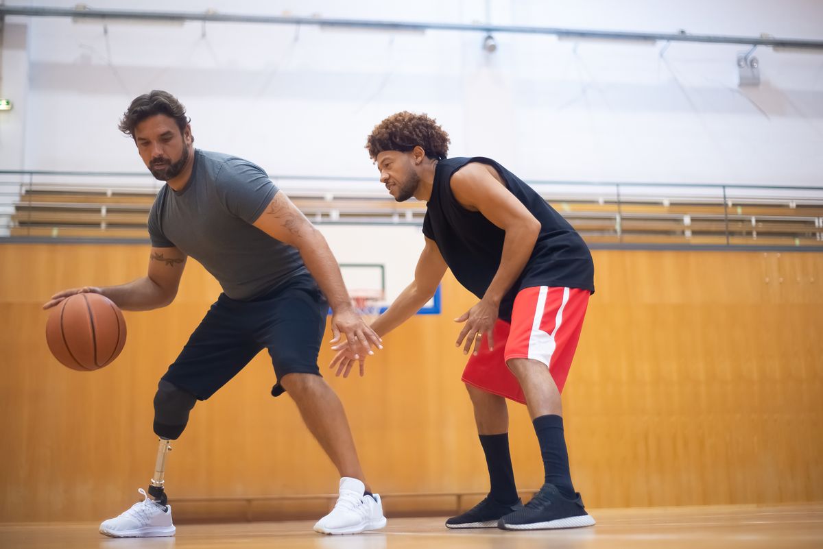 Two Summitview players running a dribbling drill in the gym