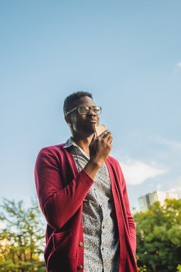 Cheerful Black Man With Smartphone On Street